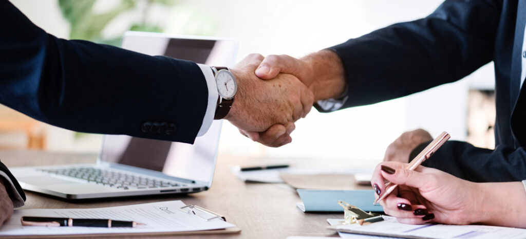Business handshake across a desk