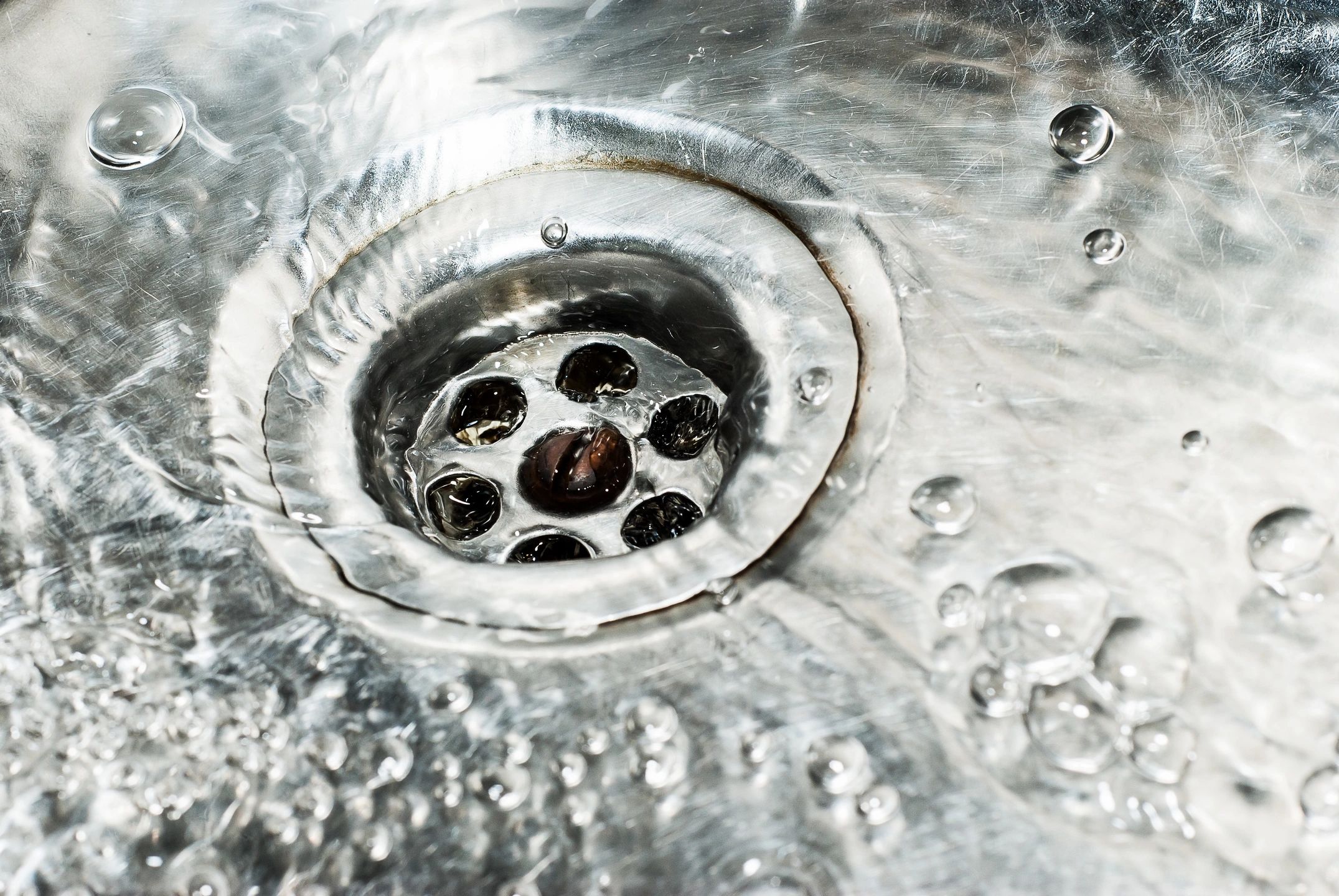 clean water draining into a stainless steel sink